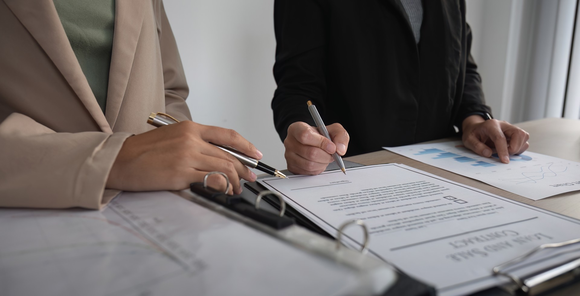 Close-up of the agreement document being signed. Business contract of young businesswoman